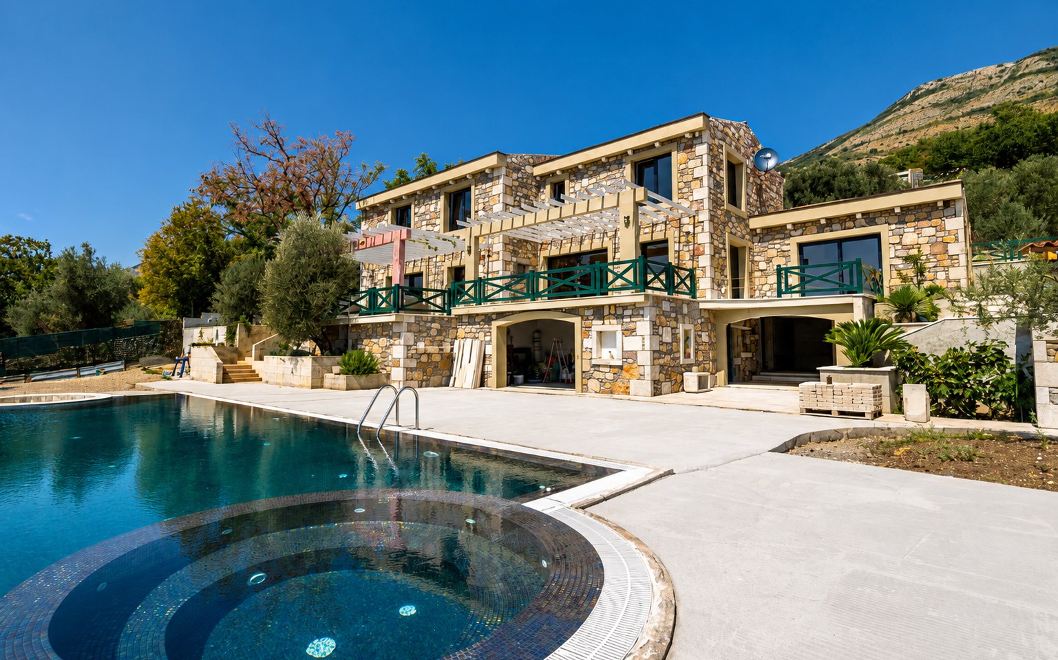 Pool, jacuzzi and pergola at Paštrovići Stone Retreat with mountains beyond
